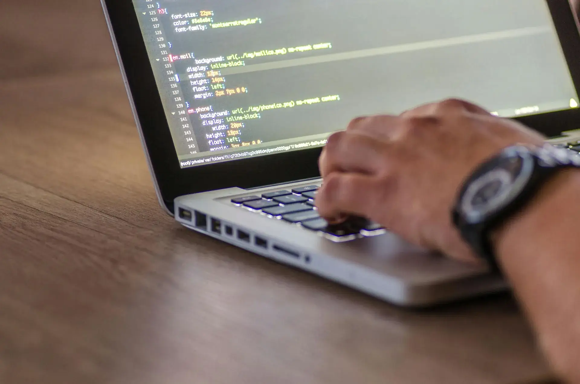 Person coding on a computer